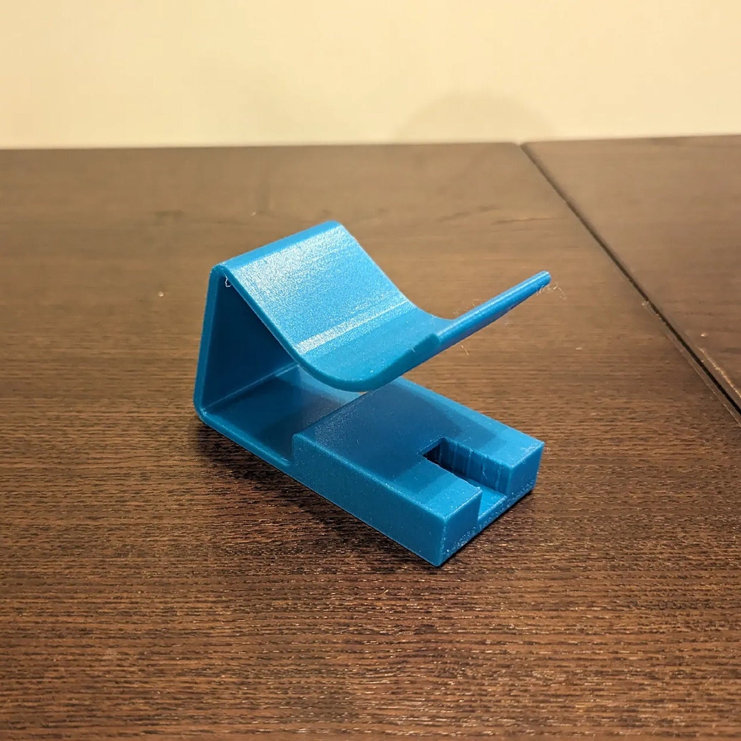 a blue object sitting on top of a wooden table