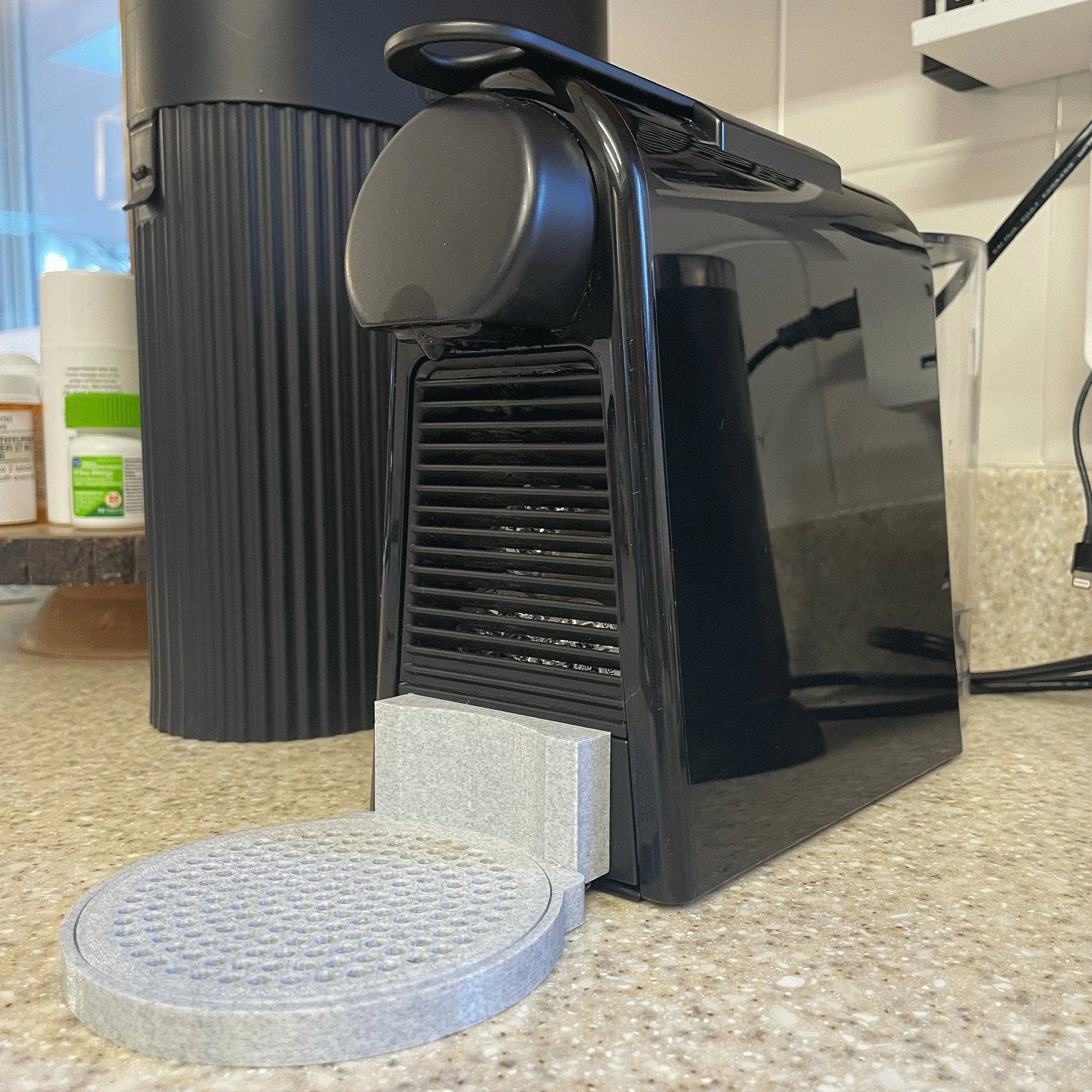 a black coffee maker sitting on top of a counter