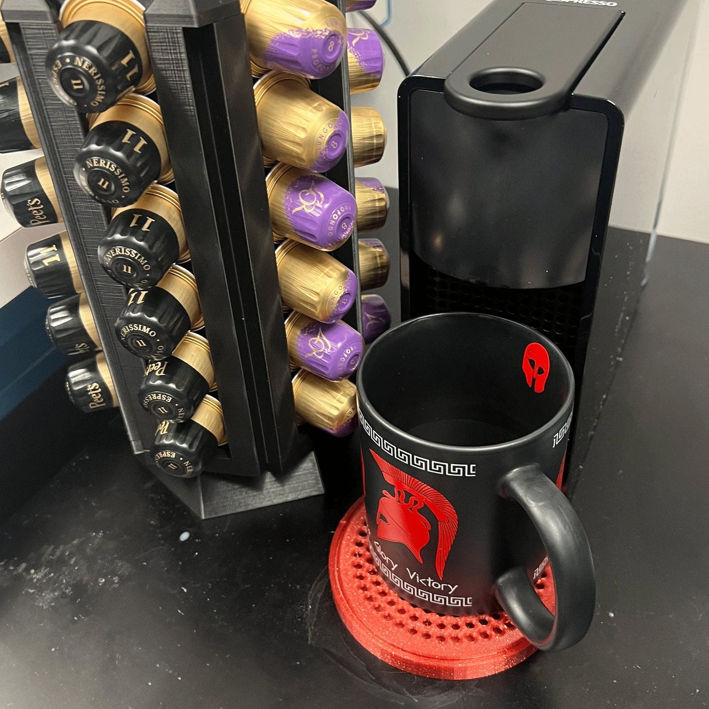 a coffee cup sitting next to a coffee maker