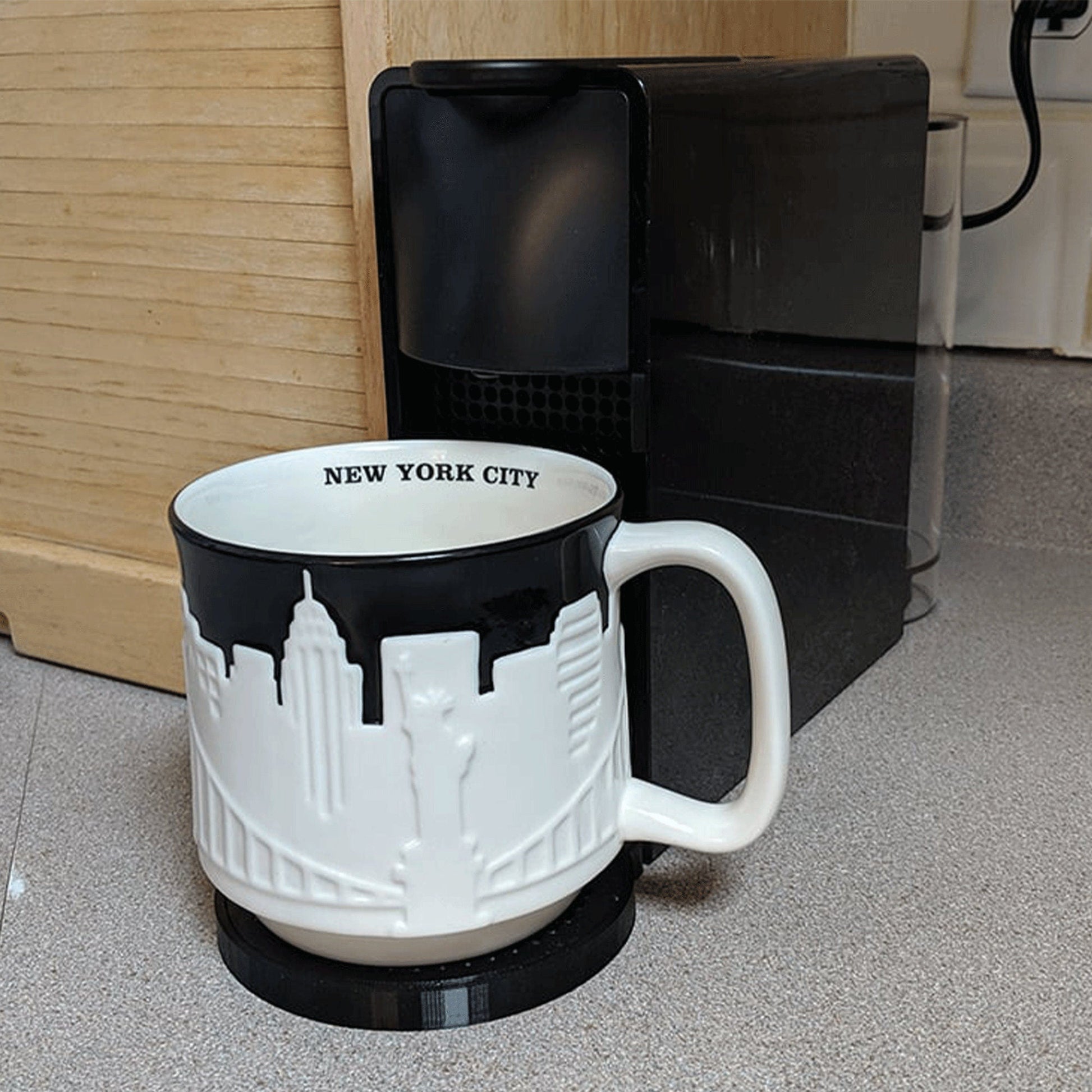 a black and white coffee mug sitting on a counter