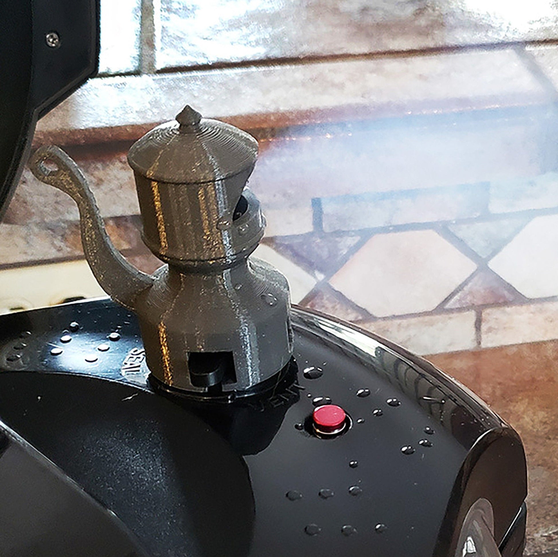 a coffee pot sitting on top of a machine