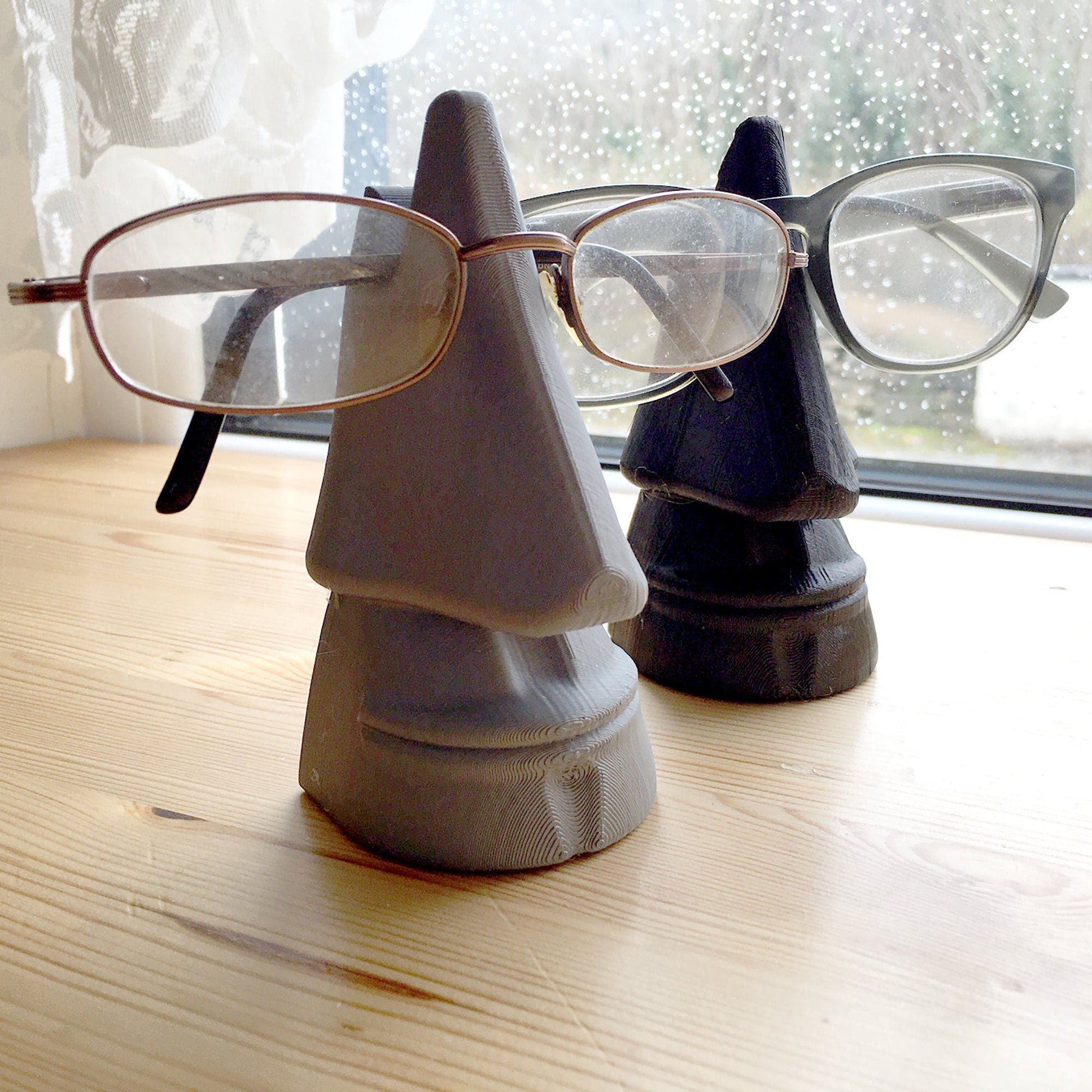 a pair of glasses sitting on top of a wooden table