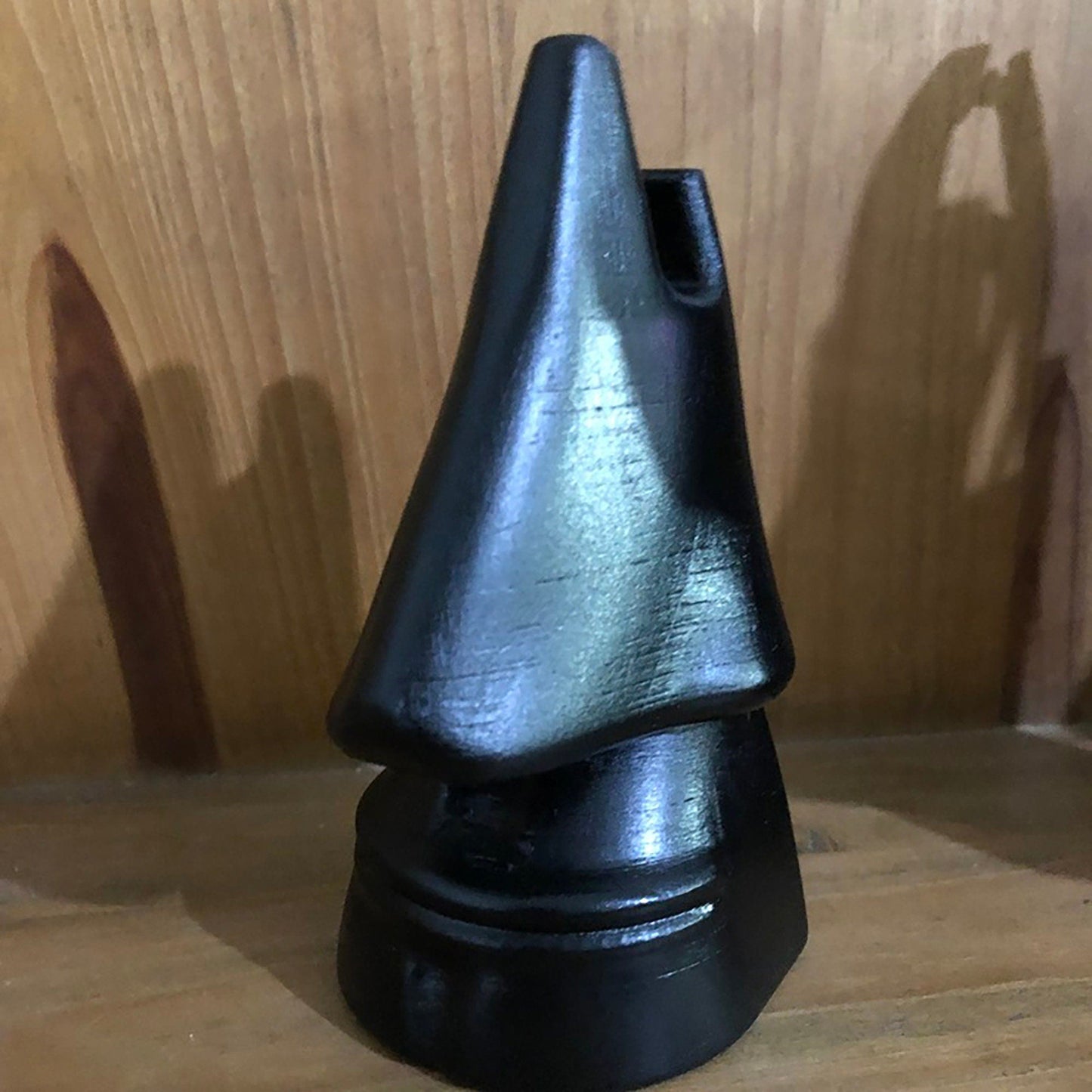 a black object sitting on top of a wooden table