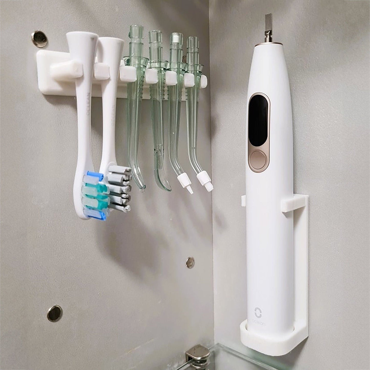 a toothbrush and toothpaste dispenser on a wall