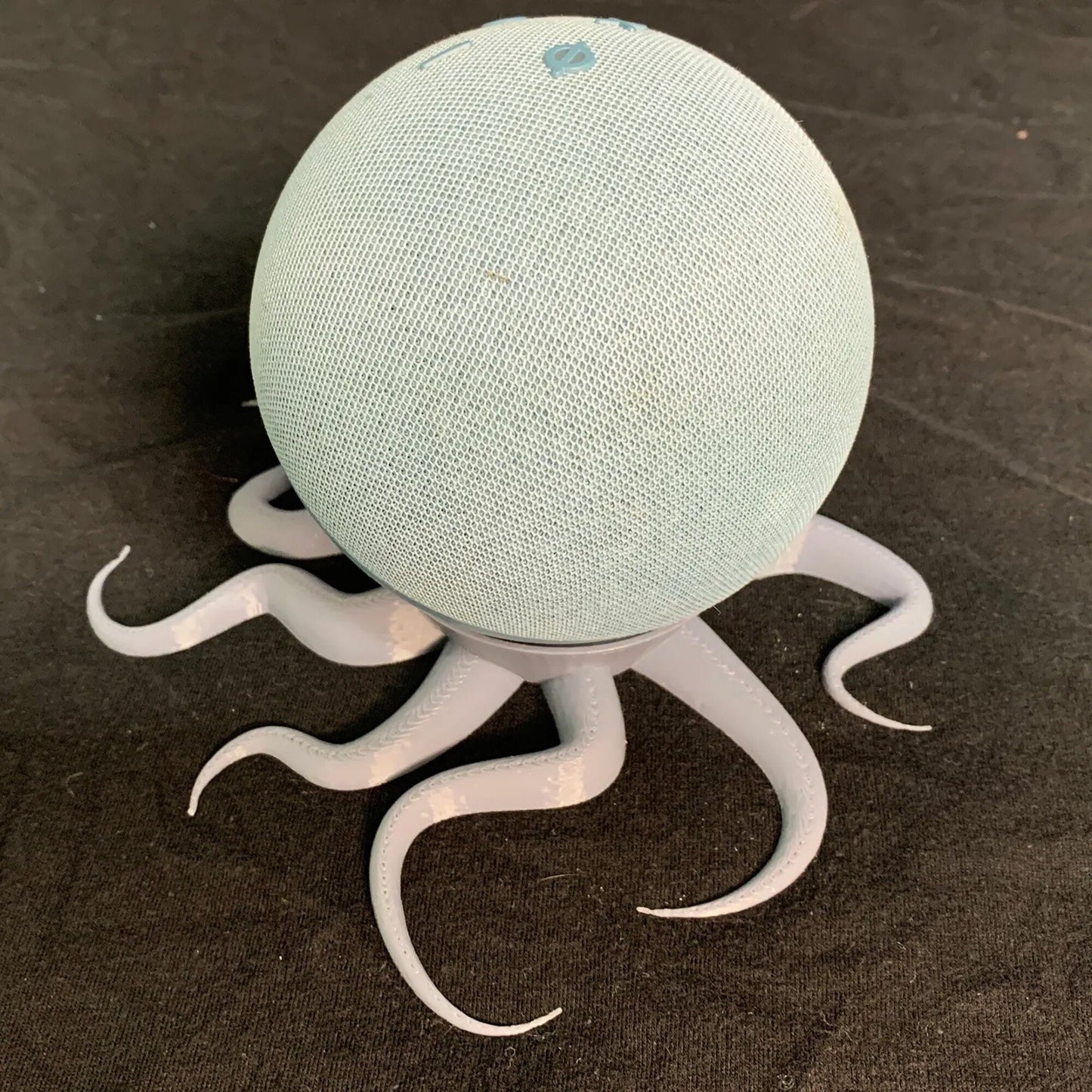 a blue and white speaker sitting on top of a table