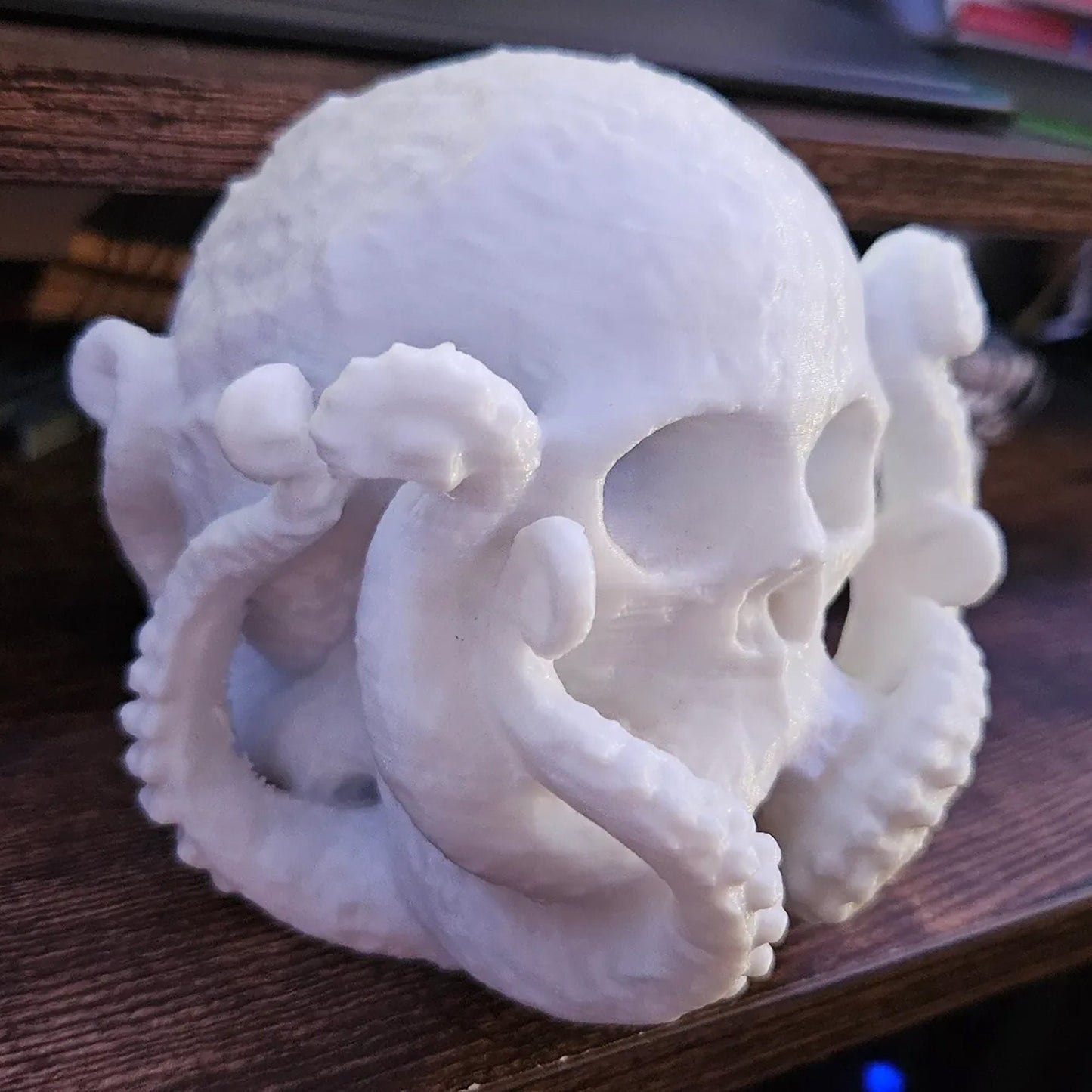 a white sculpture of a human skull on a table