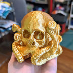 Octopus skull figurine with tentacles wrapped around a human skull, view 3