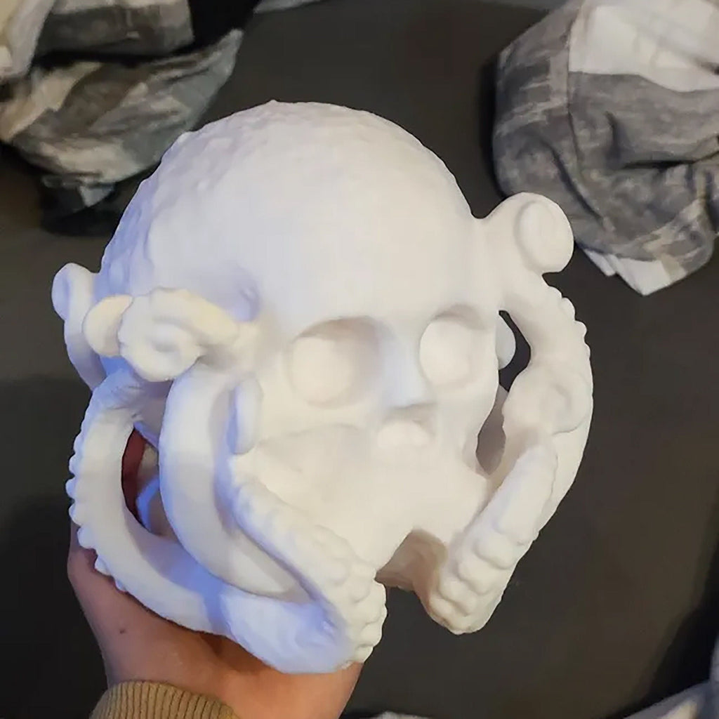 Octopus skull figurine with tentacles wrapped around a human skull, view 4