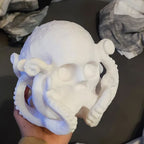 Octopus skull figurine with tentacles wrapped around a human skull, view 4
