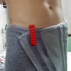 Body towel clip with ribbed jaws holding a bath towel closed at the waist