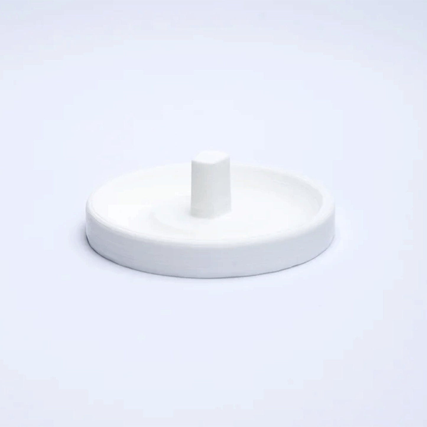 a white object is sitting on a white surface