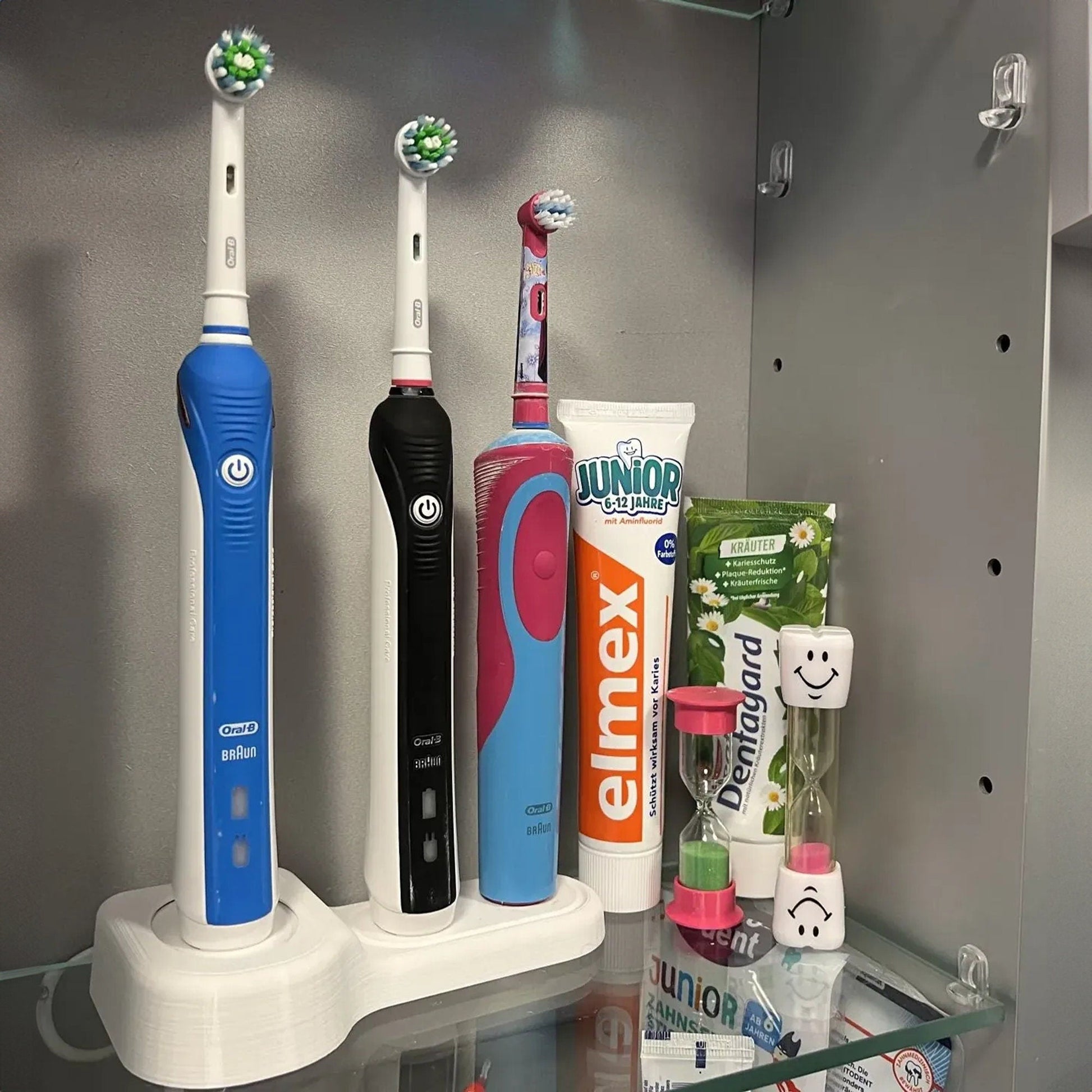 a couple of toothbrushes that are on a shelf