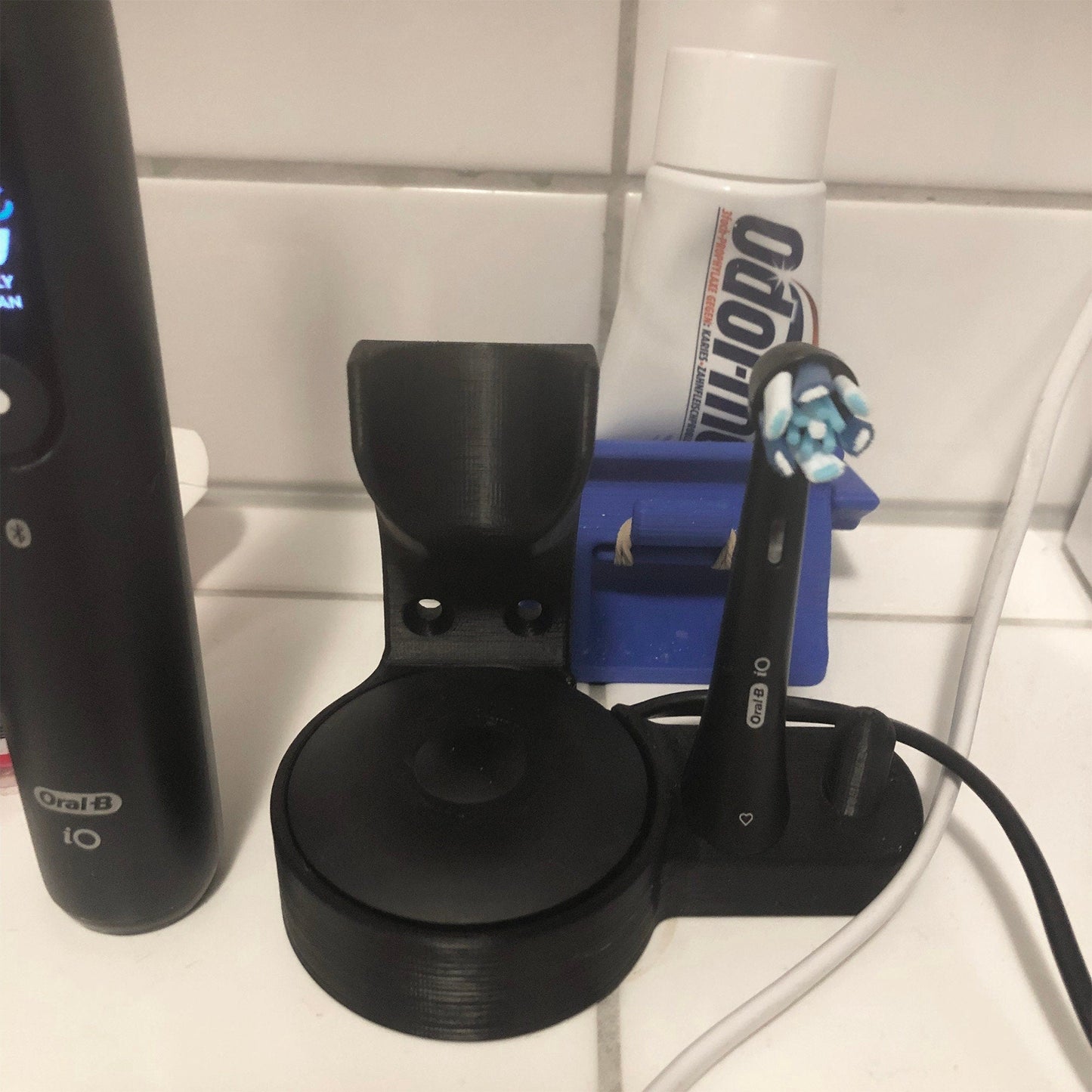 a toothbrush, toothpaste, and toothpaste dispenser