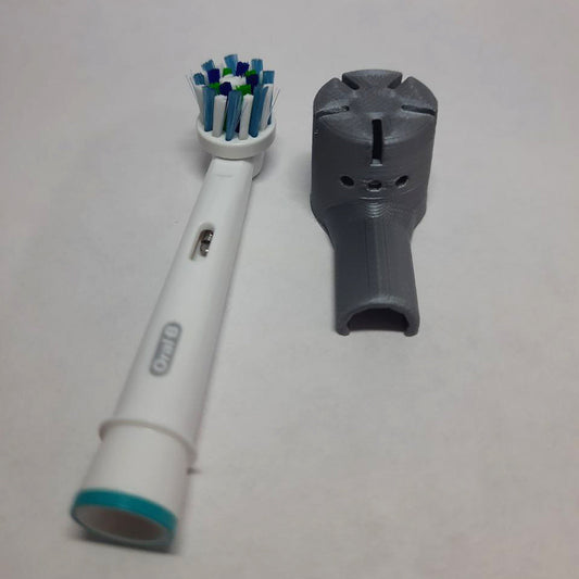 a toothbrush and a toothpaste holder on a table