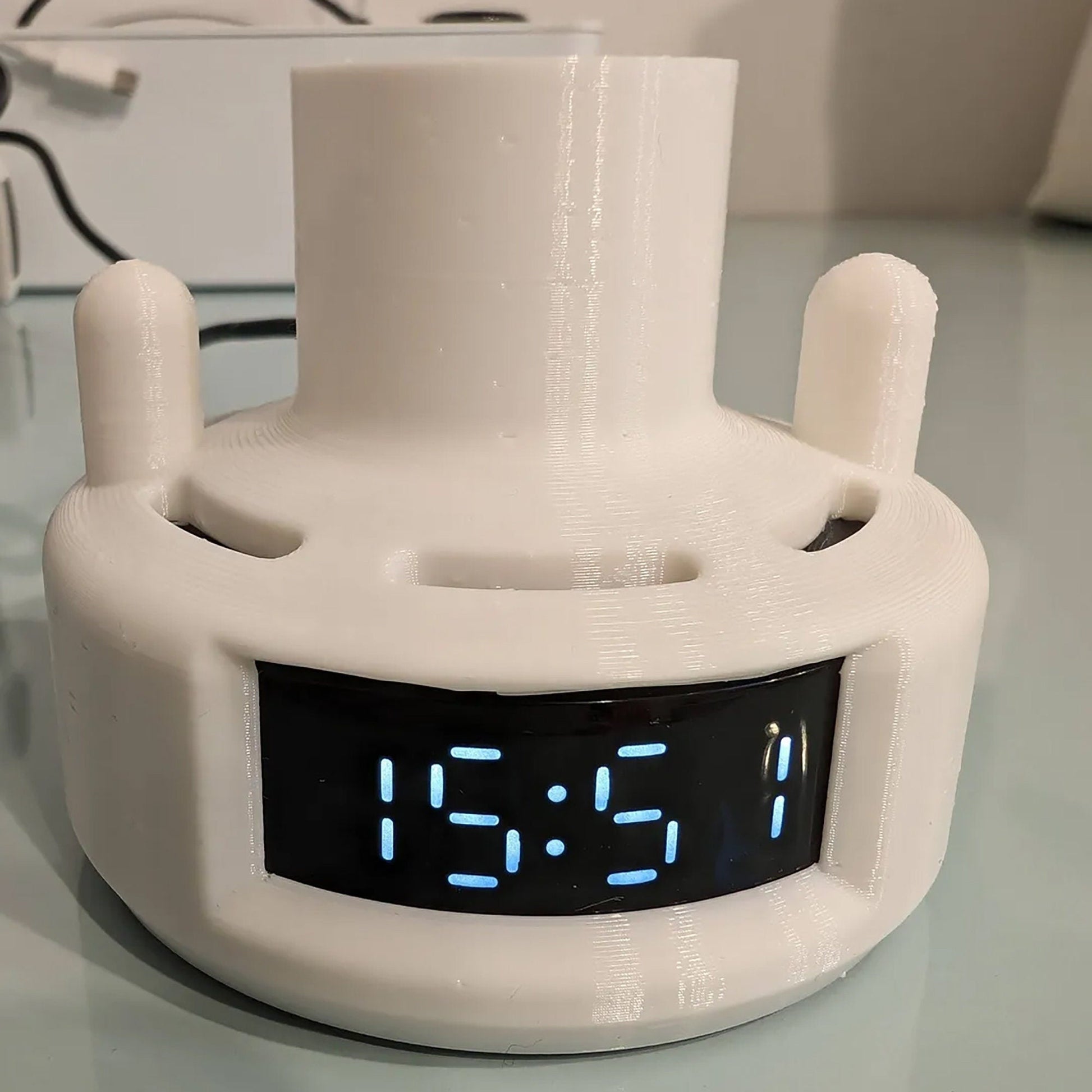 a white alarm clock sitting on top of a table