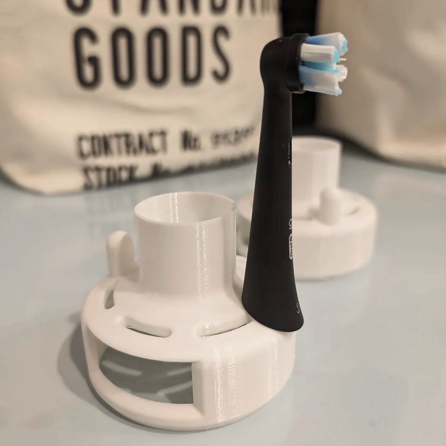 a couple of toothbrush holders sitting on top of a table