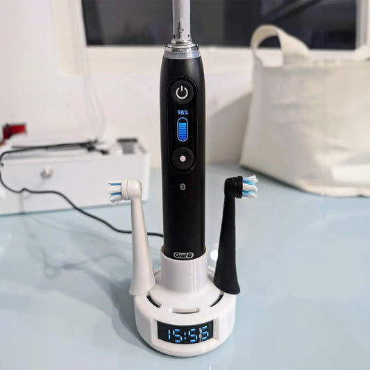 a black and white electric toothbrush sitting on top of a table