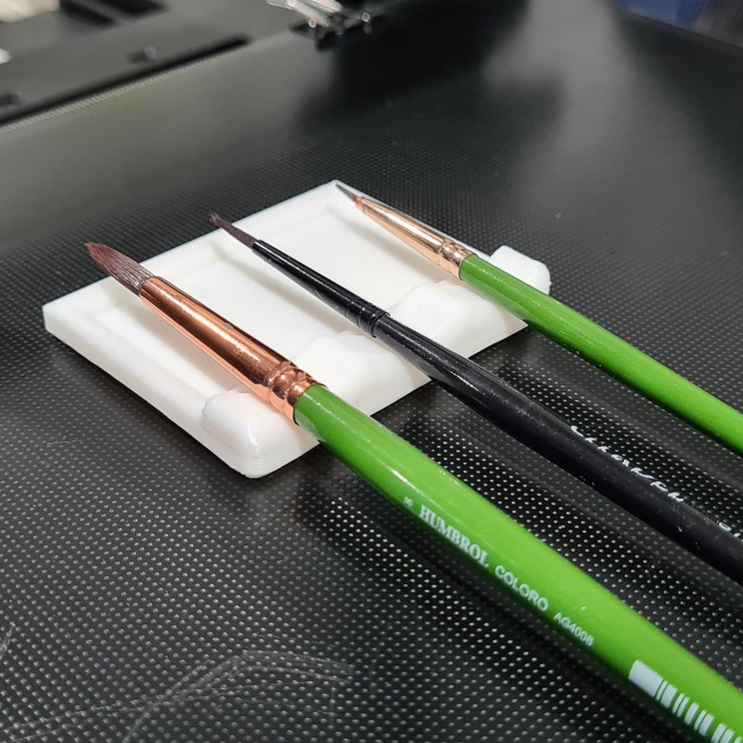 a couple of green pens sitting on top of a white plate