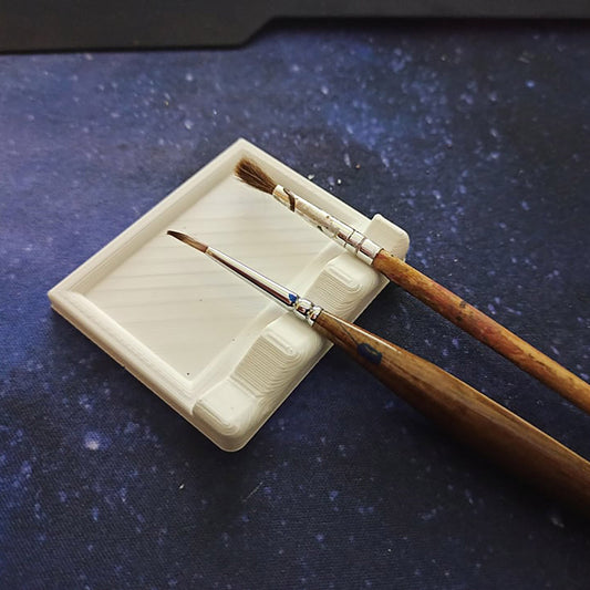 a couple of wooden brushes sitting on top of a white tray