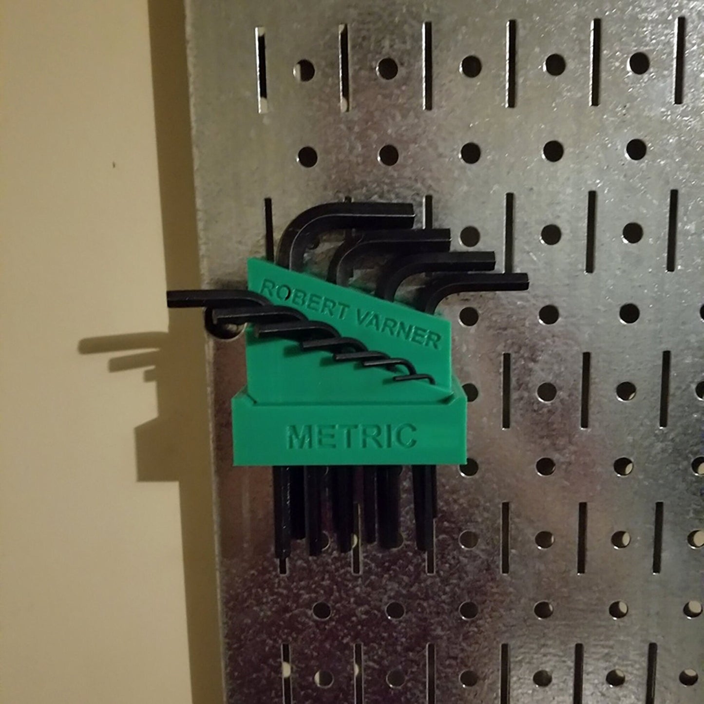 a bunch of black and green magnets on a wall