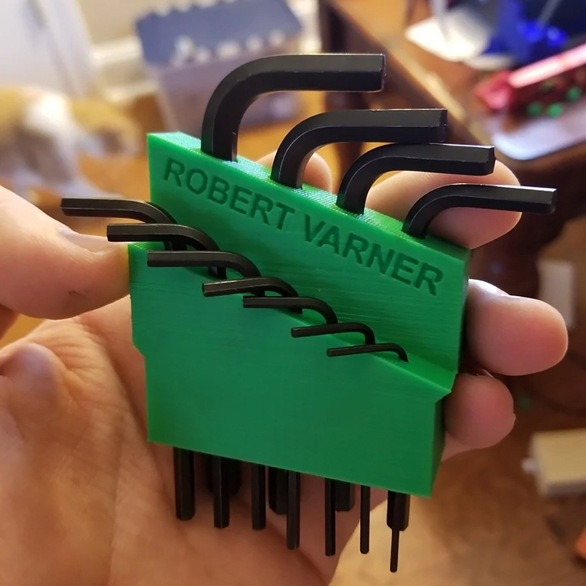 a person holding a set of black and green combs