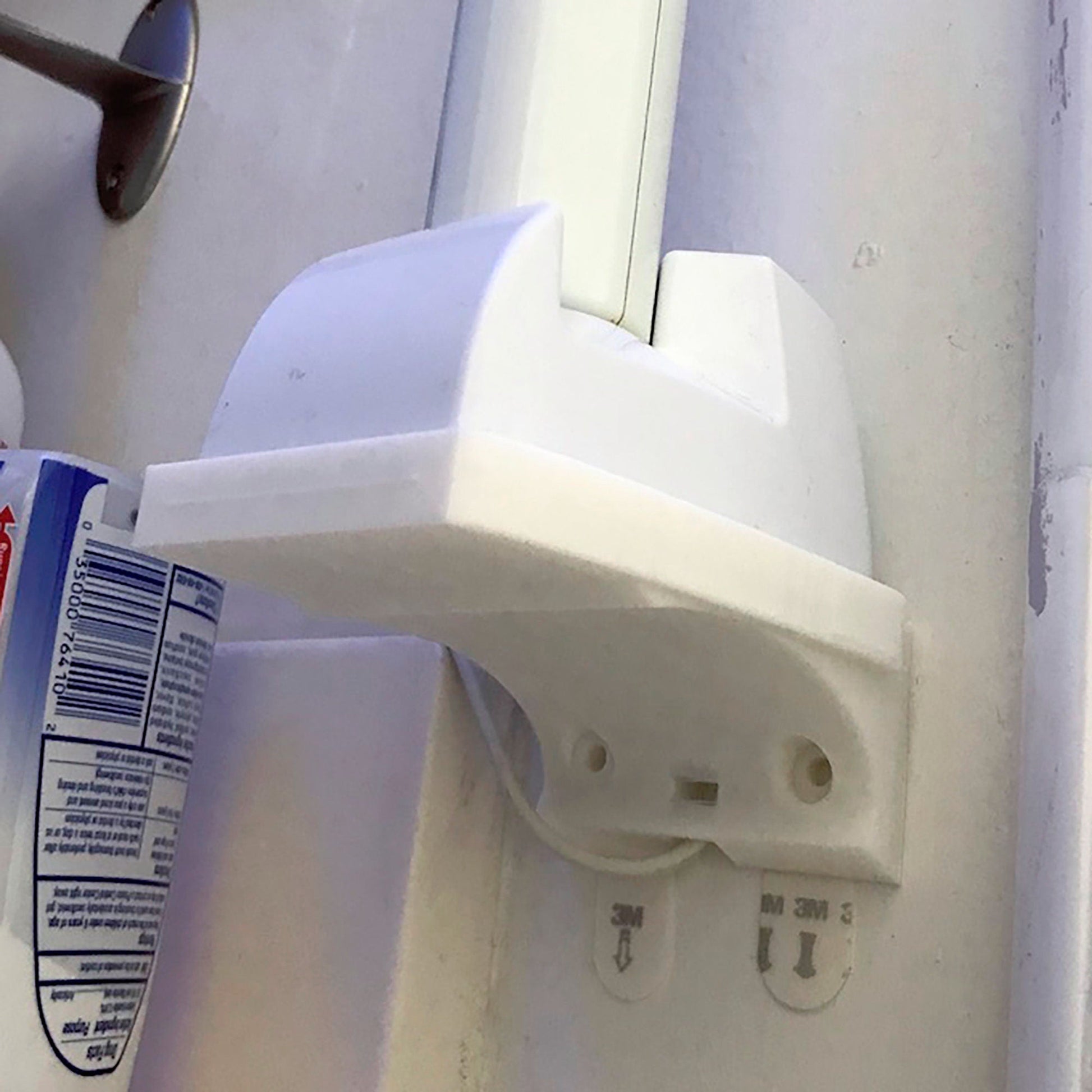 a close up of a toothbrush and a toothpaste dispenser