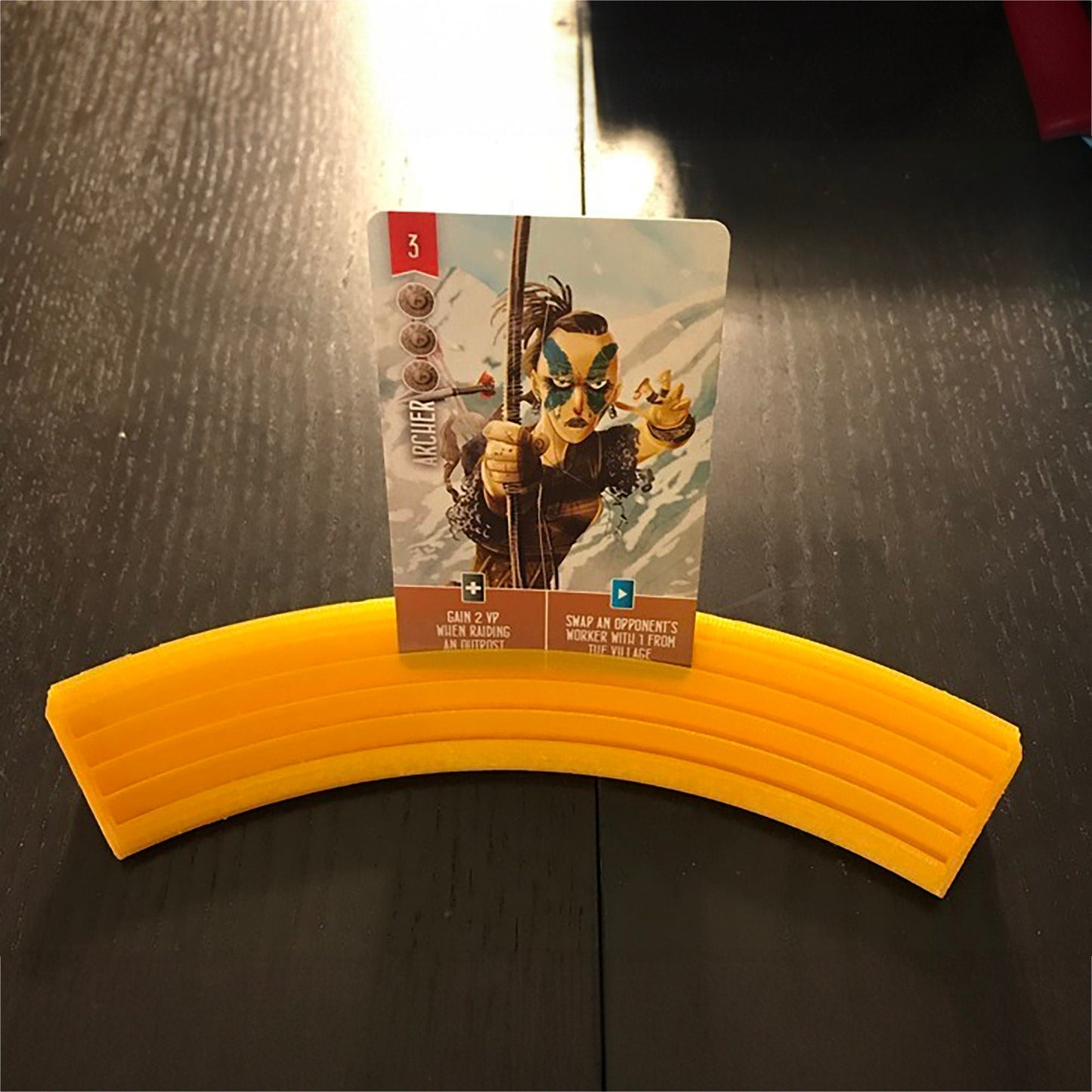 a yellow frisbee sitting on top of a wooden table