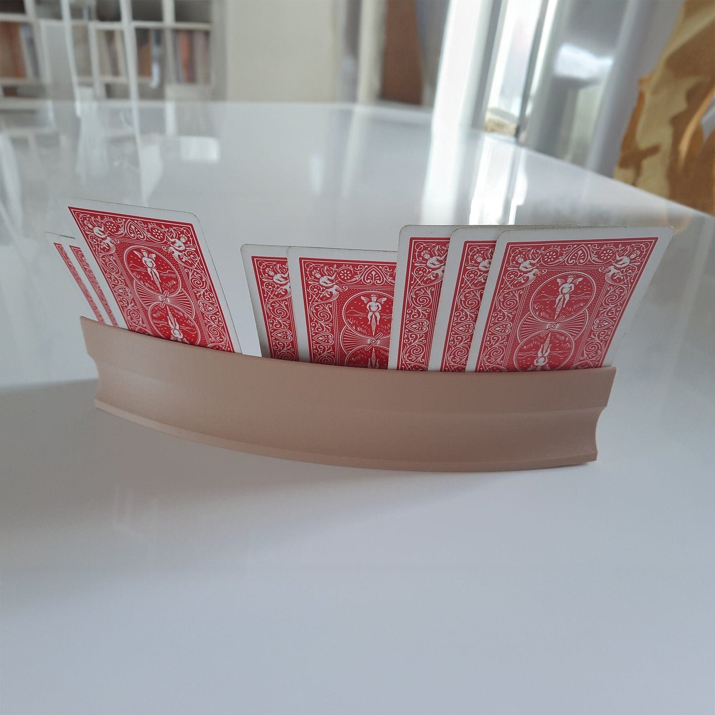 a white table topped with red playing cards