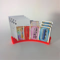 Hands-free playing card holder with a curved grooved base fanning a hand of cards