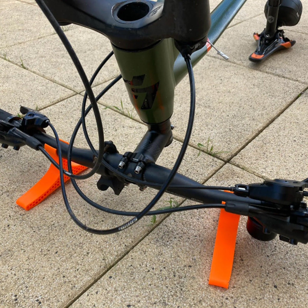 Pair of handlebar repair cradles supporting an upside-down mountain bike, view 3