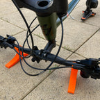 Pair of handlebar repair cradles supporting an upside-down mountain bike, view 3