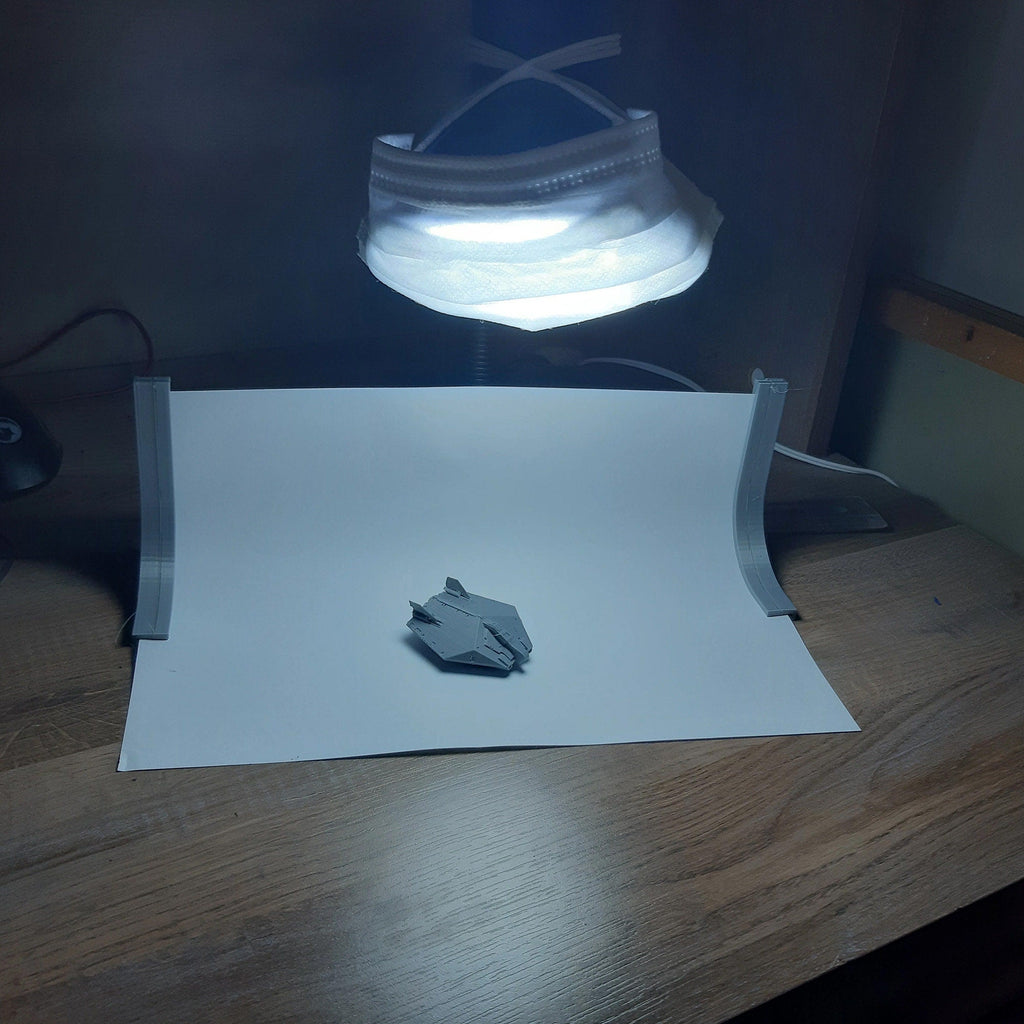 Portable photo studio stand holding a paper backdrop for small product photos, view 4