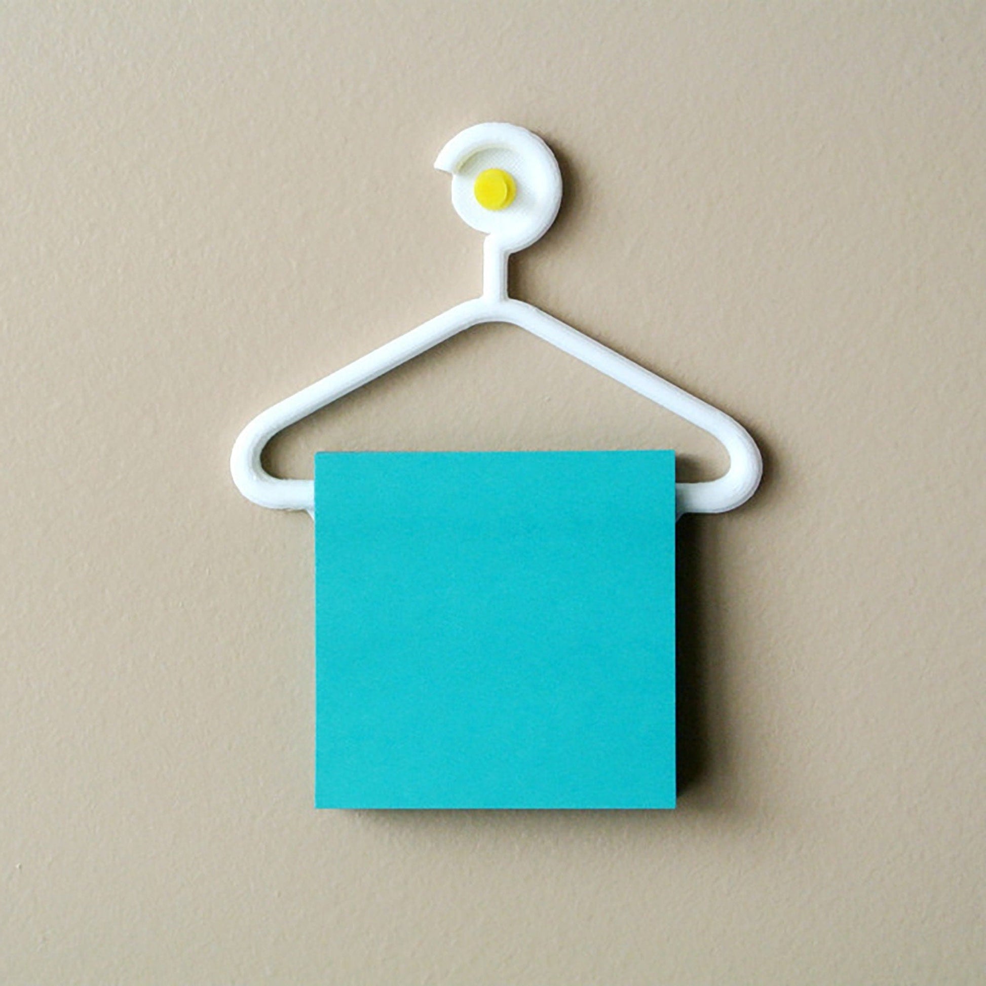 a blue piece of paper hanging from a white hanger