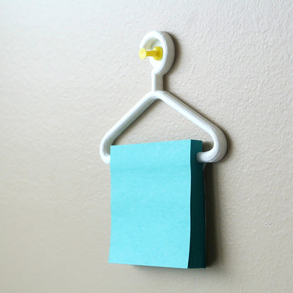 Mini coat hanger sticky note holder pinned to a cork board, view 3