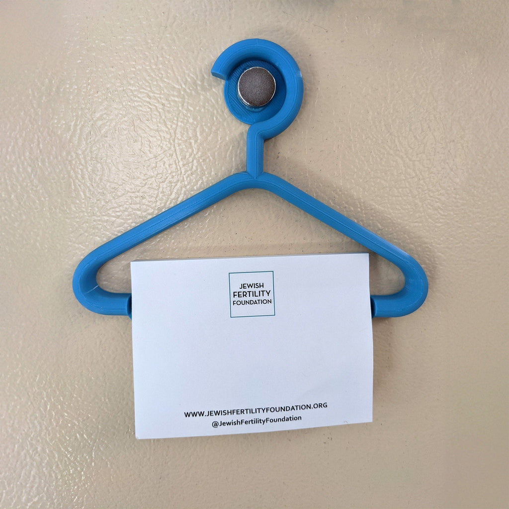 Mini coat hanger sticky note holder pinned to a cork board, view 5