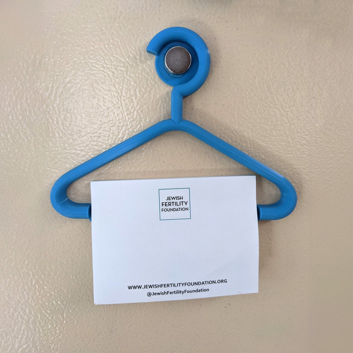 a piece of paper hanging from a blue hanger