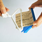 Mini coat hanger sticky note holder pinned to a cork board, view 6