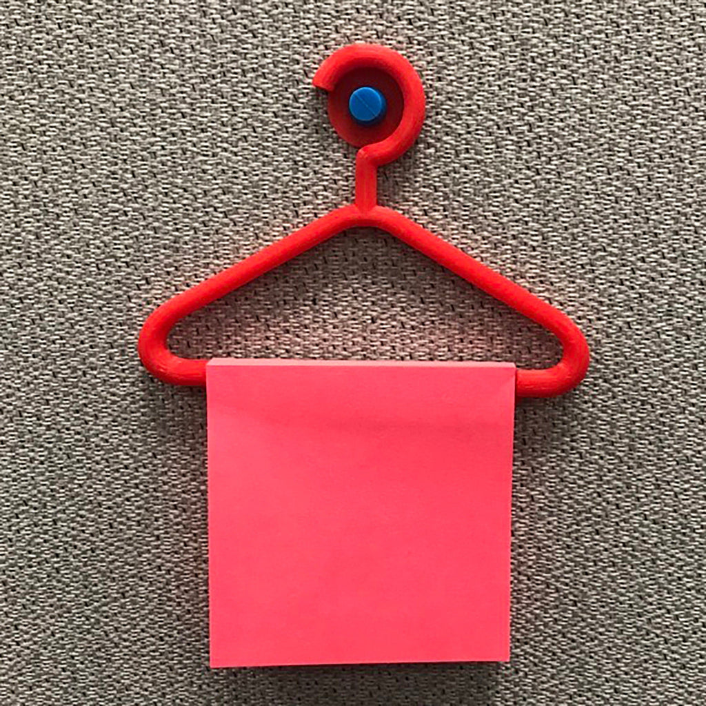 Mini coat hanger sticky note holder pinned to a cork board
