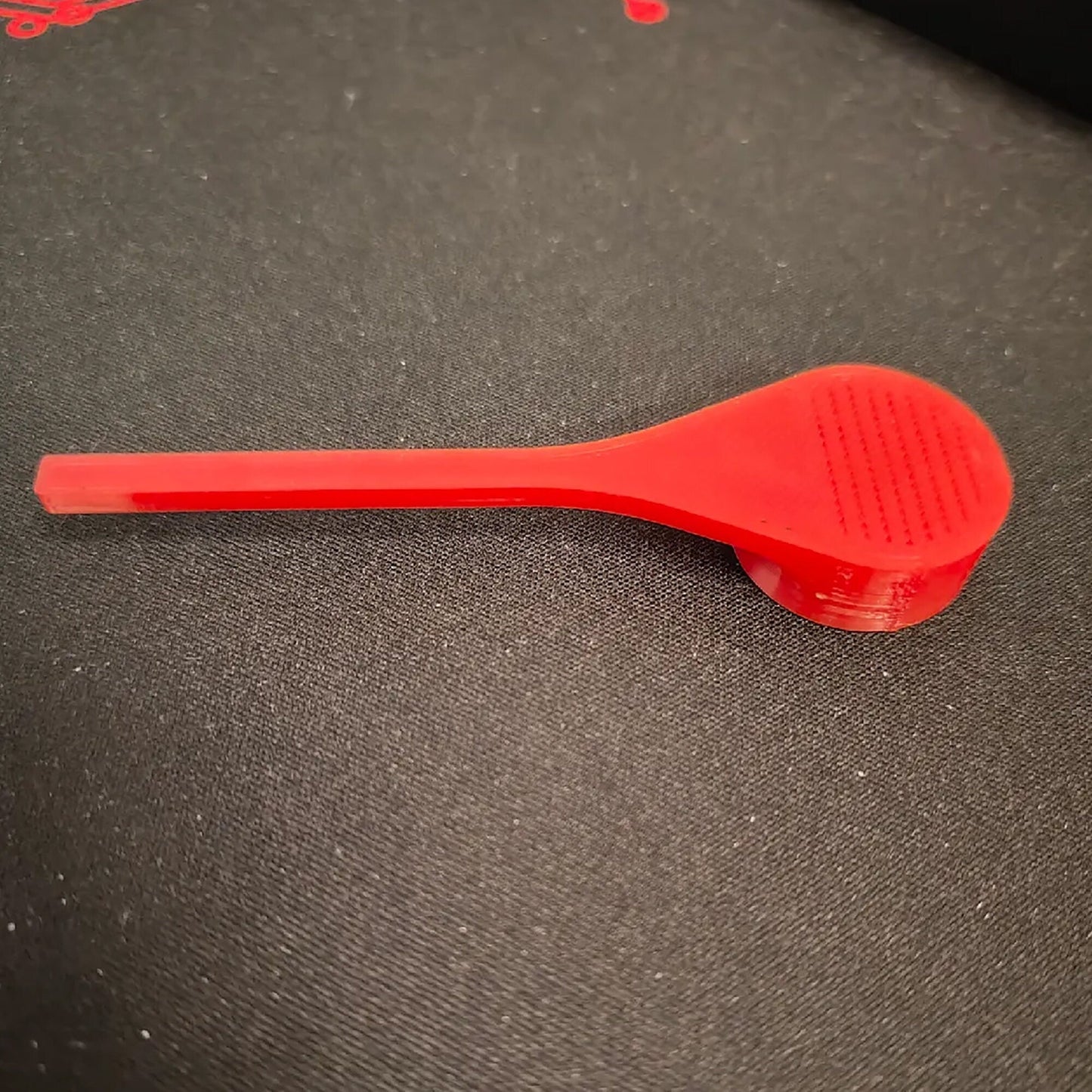 a red brush sitting on top of a table