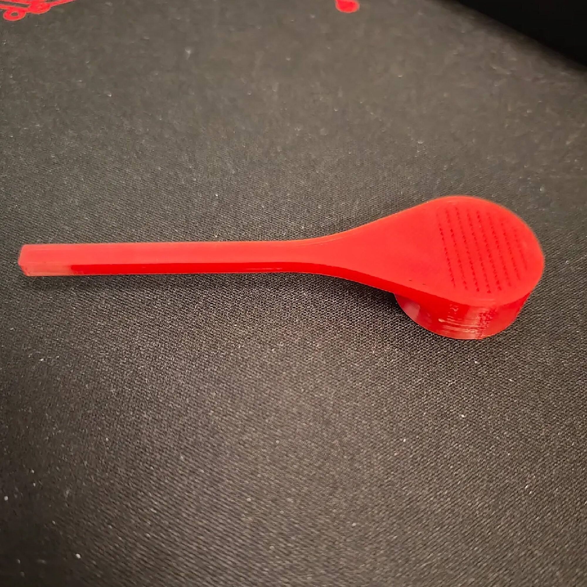 a red brush sitting on top of a table
