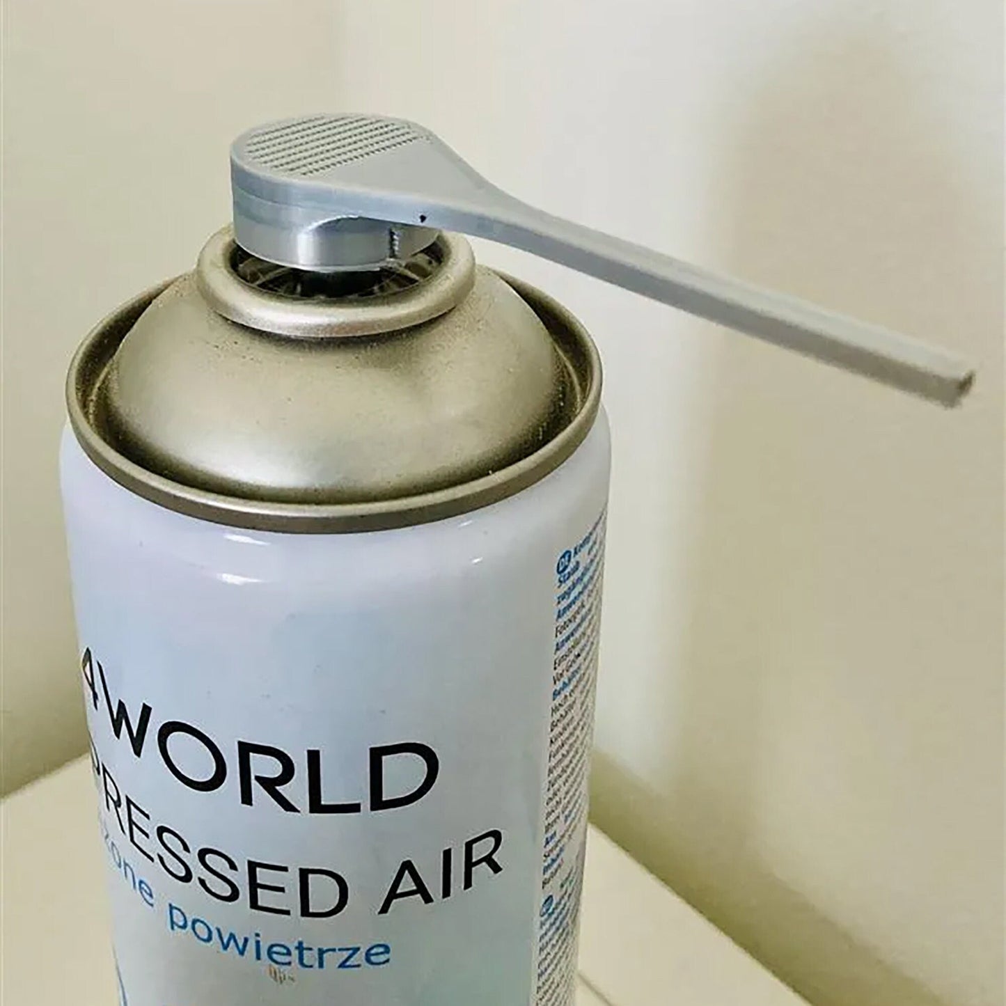 a can of air freshener sitting on a counter