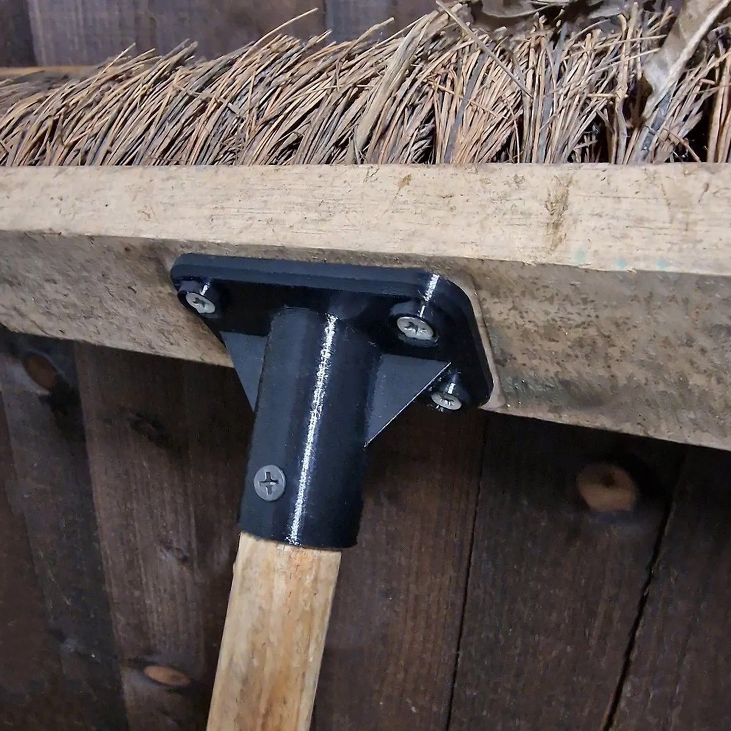 a close up of a hammer on a piece of wood