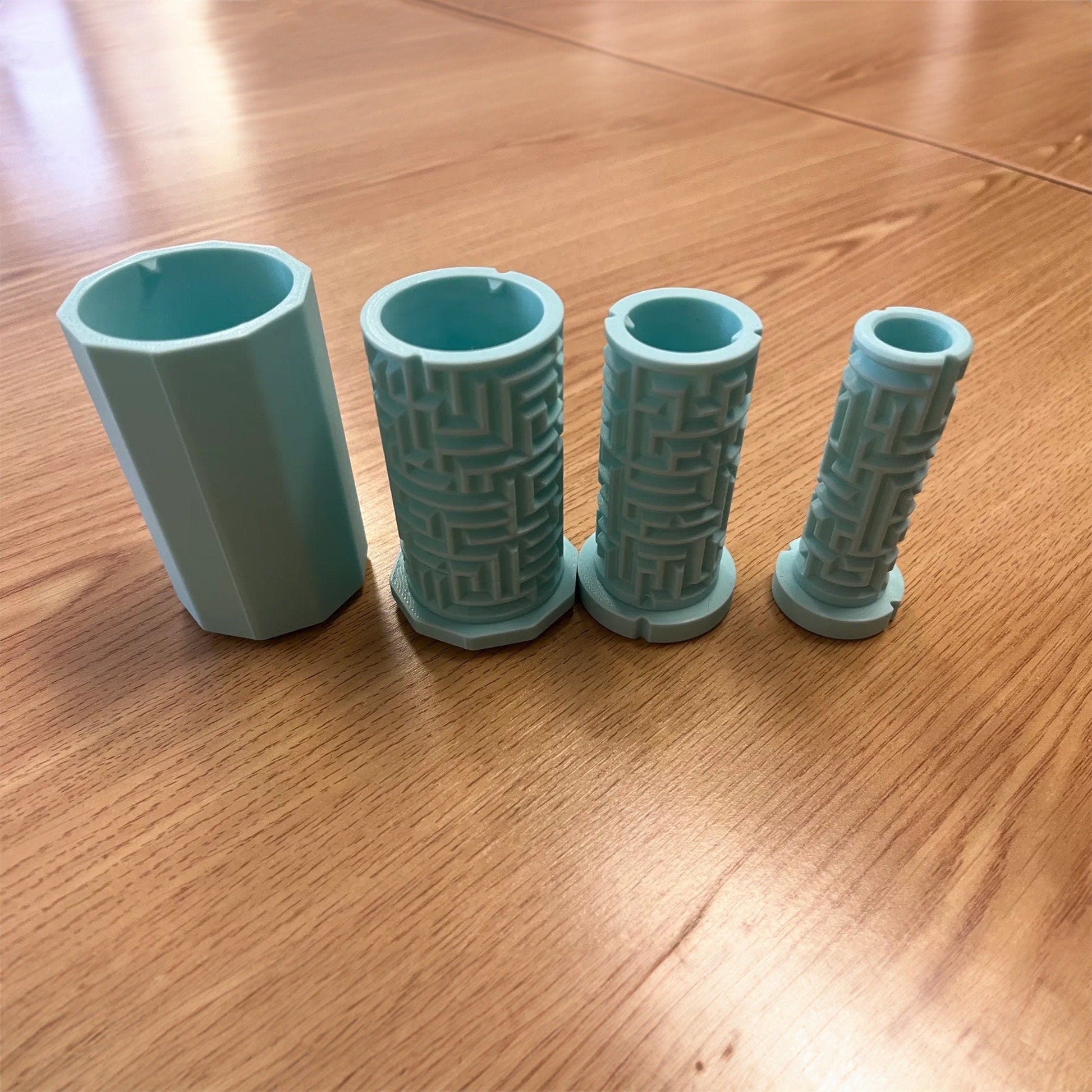 three blue vases sitting on top of a wooden table