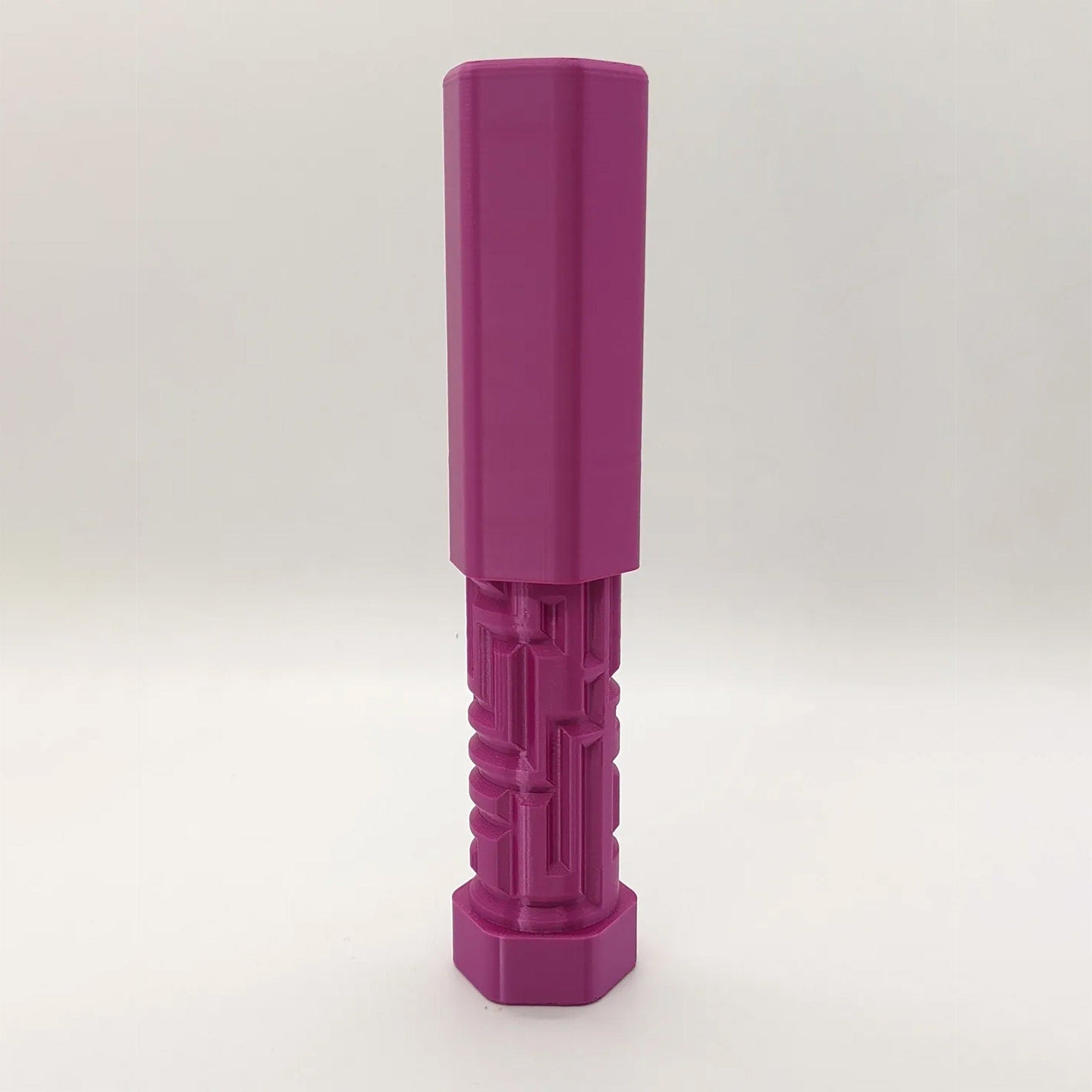 a purple plastic object on a white background