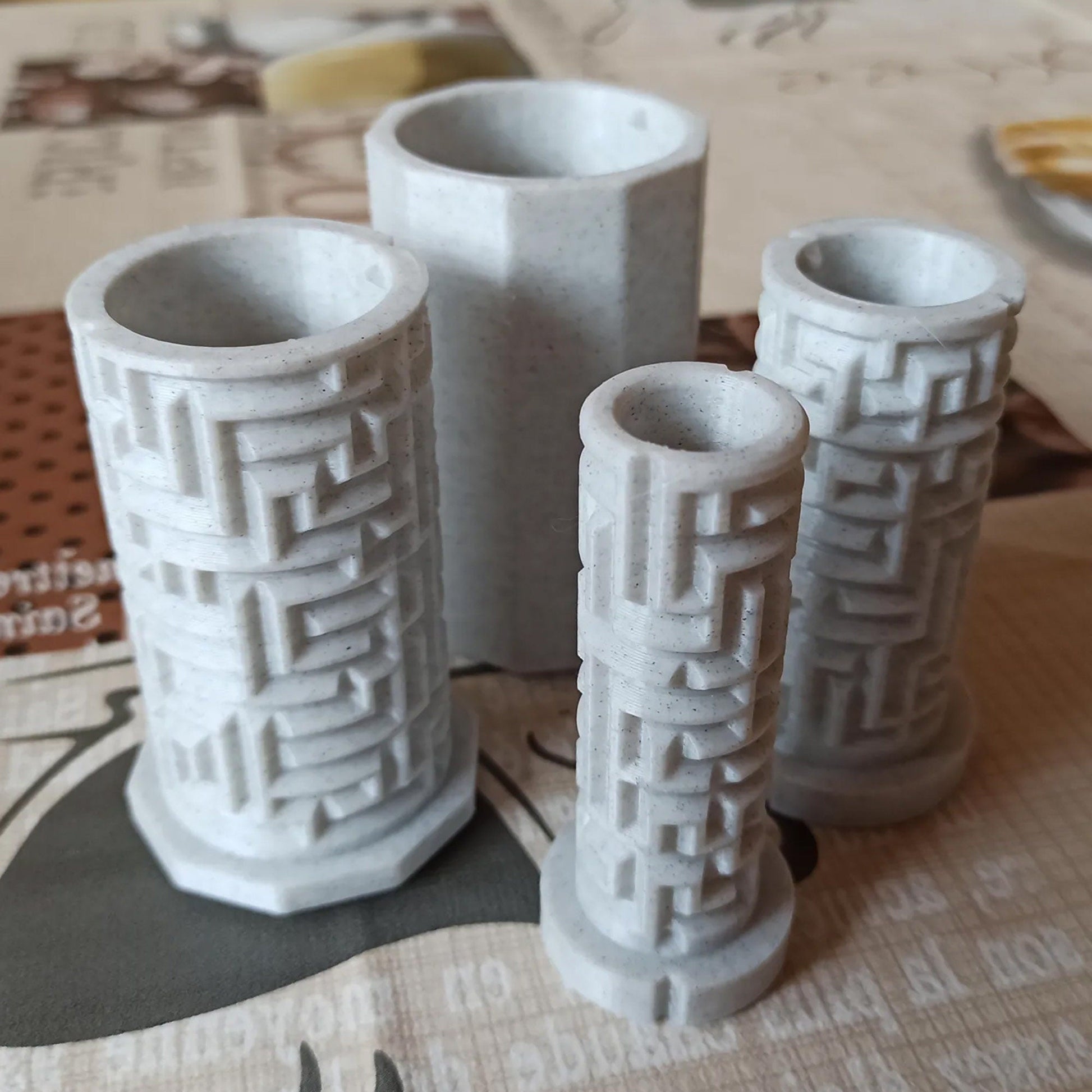 three white vases sitting on top of a table