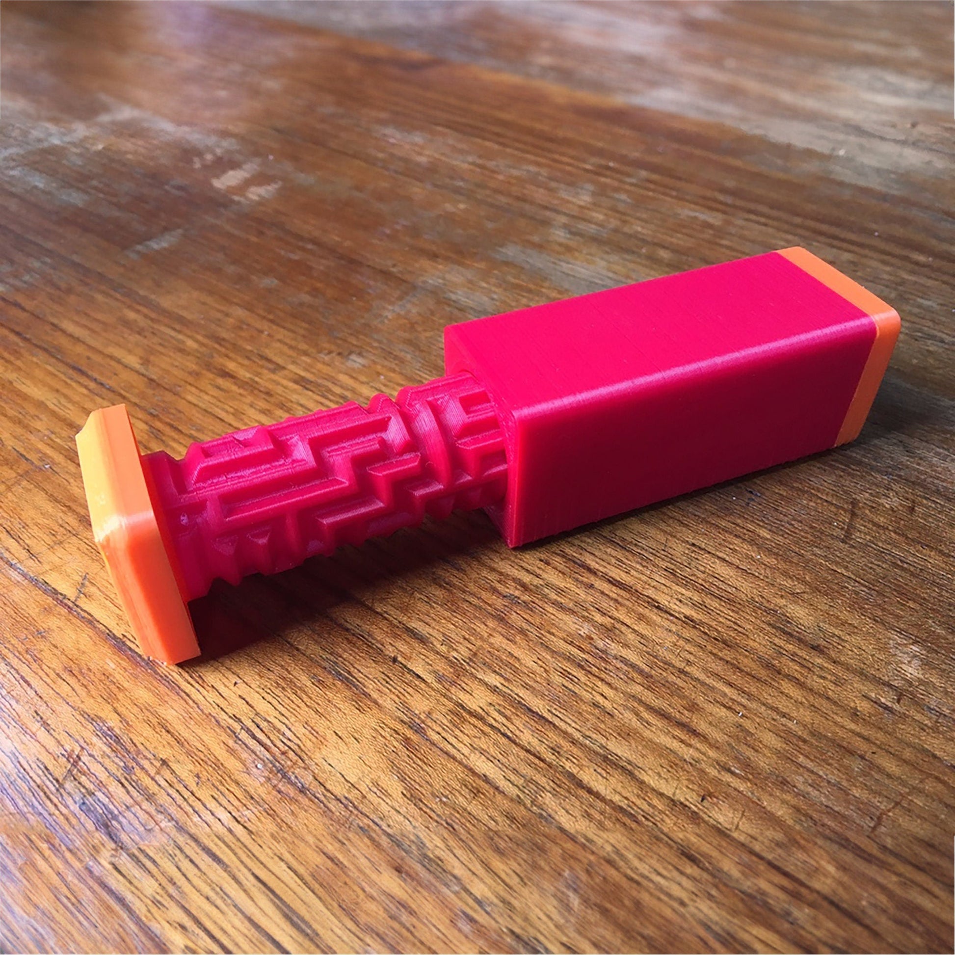 a pink object sitting on top of a wooden table