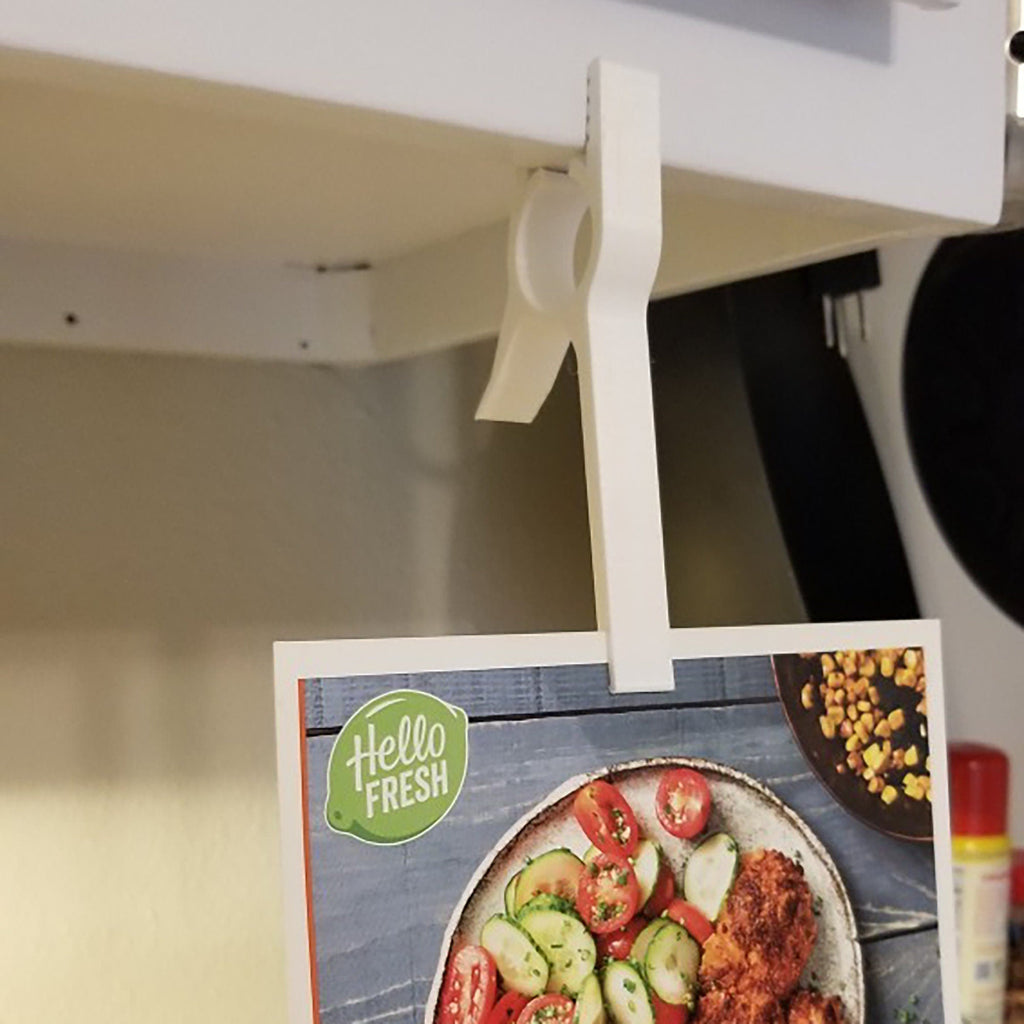 Under cabinet clip holding a recipe card at eye level, view 2