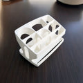 Remote control caddy with six slots holding TV and streaming remotes