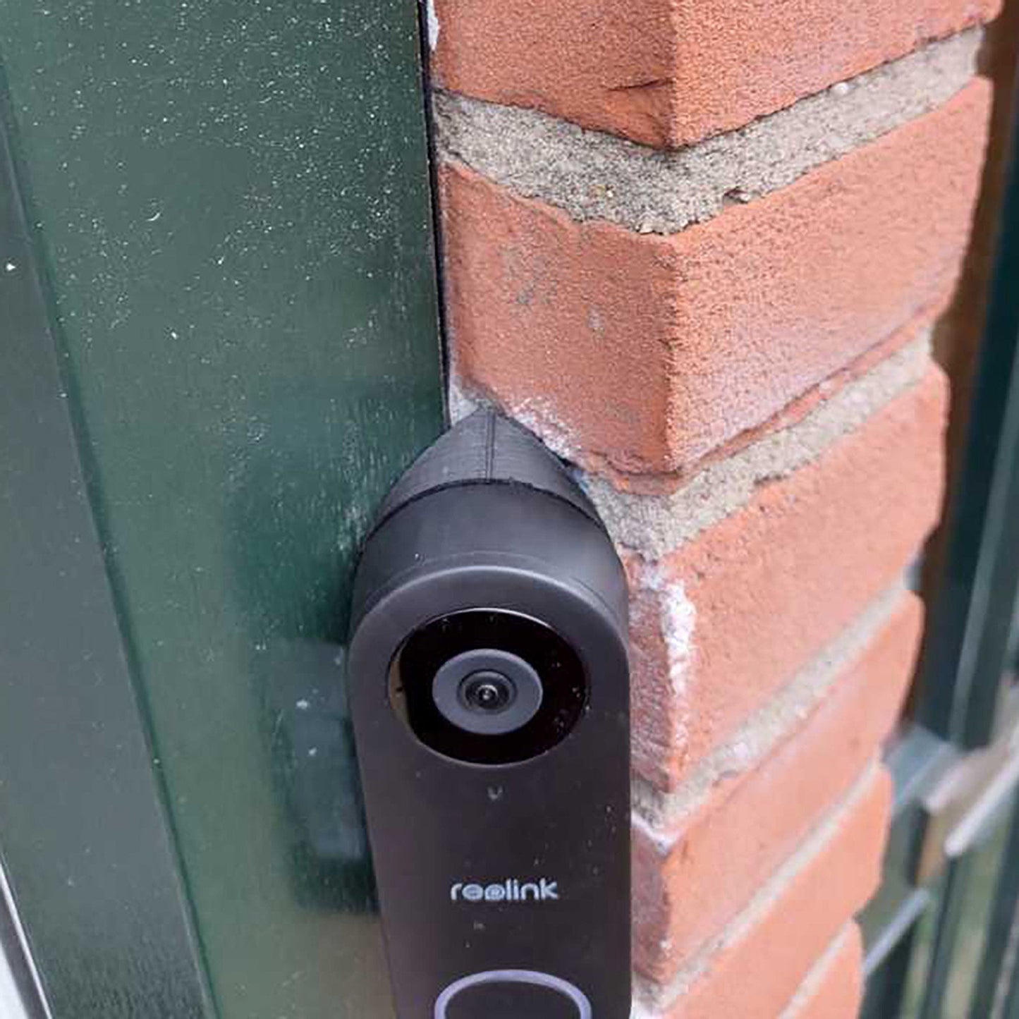 a camera mounted to the side of a brick building