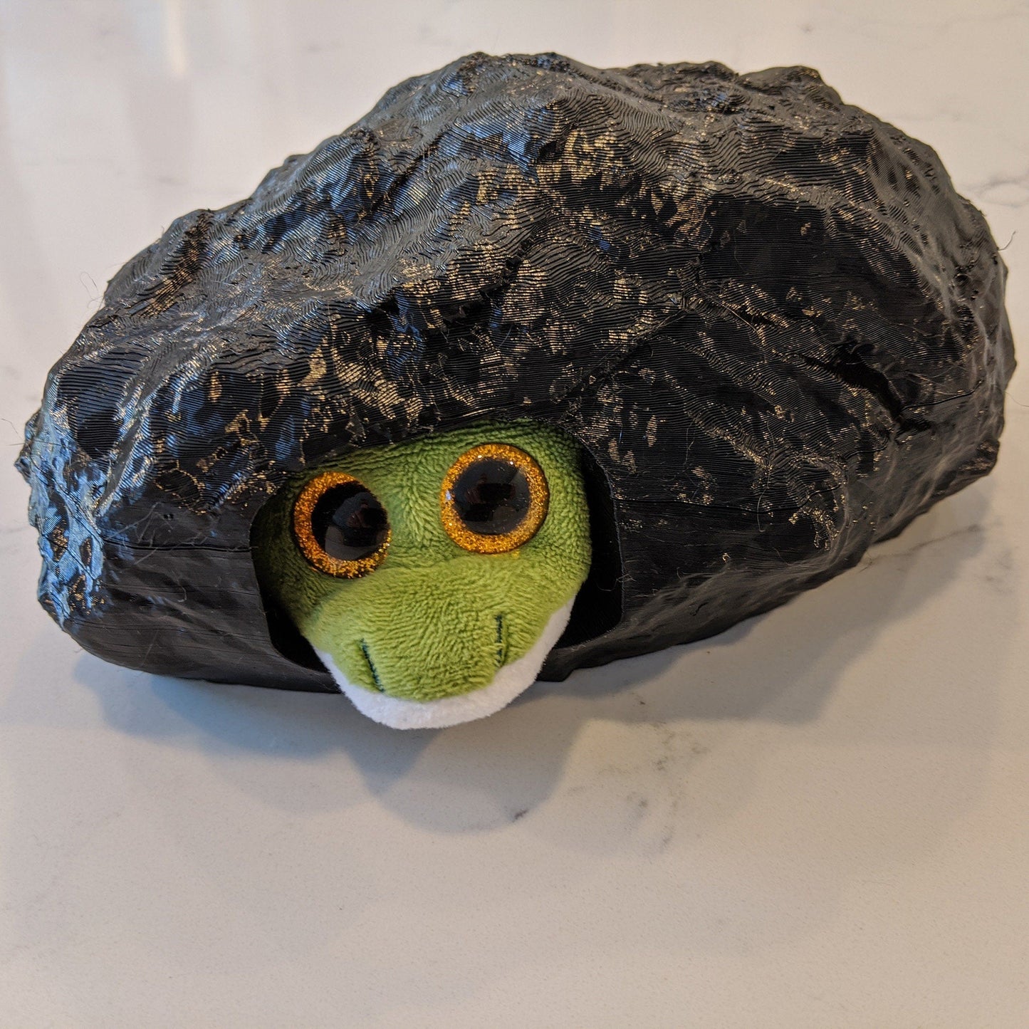 a stuffed animal in a rock on a table